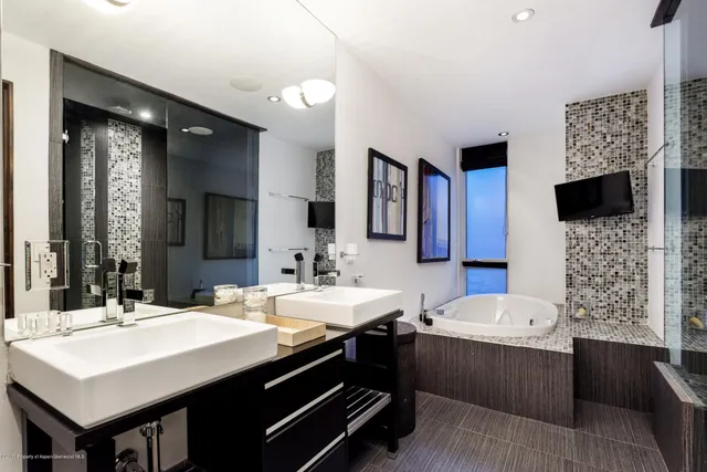 a bathroom with a sink double vanity and a mirror