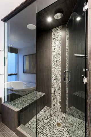 a bathroom with a sink a toilet and shower