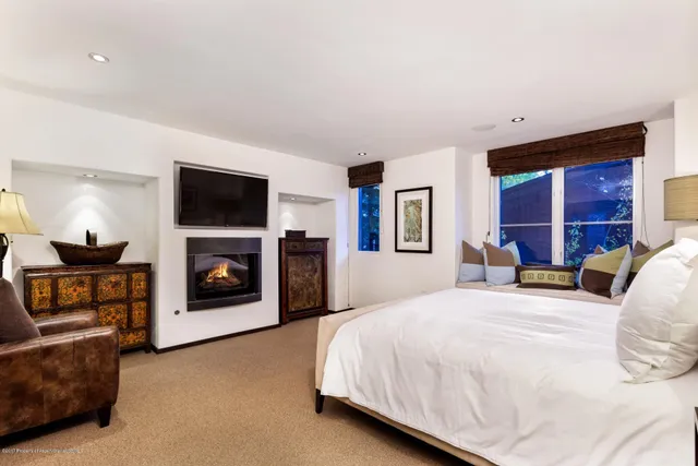 a bedroom with a bed and a fireplace