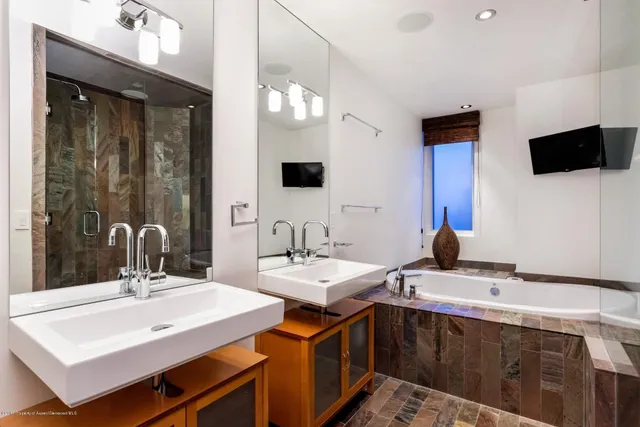 a bathroom with a sink double vanity and a mirror