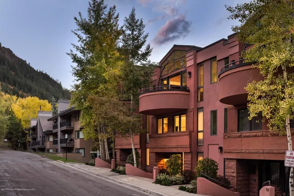 a front view of a building with a yard