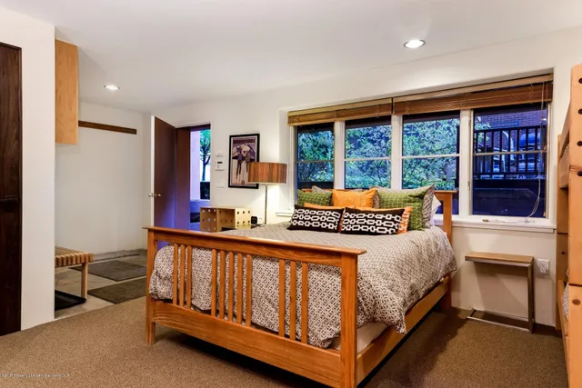 a bed room with a bed and a large window