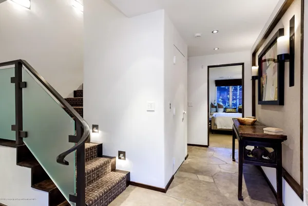 a view of a livingroom with furniture and stairs