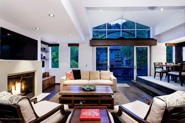 a living room with furniture fireplace and flat screen tv
