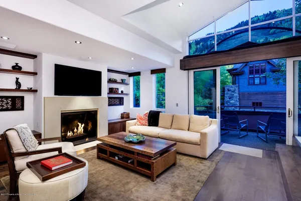 a living room with furniture flat screen tv and a fireplace