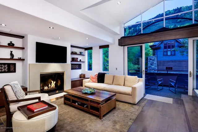a living room with furniture flat screen tv and a fireplace