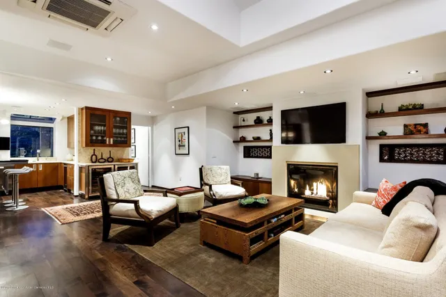 a living room with furniture fireplace and flat screen tv