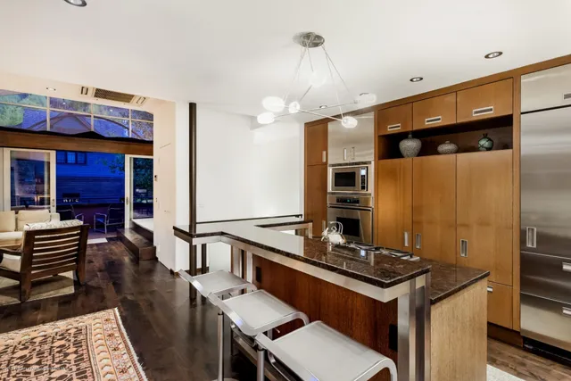 a kitchen with stainless steel appliances granite countertop a stove and a refrigerator