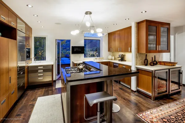 a kitchen that has a lot of cabinets a sink and a stove