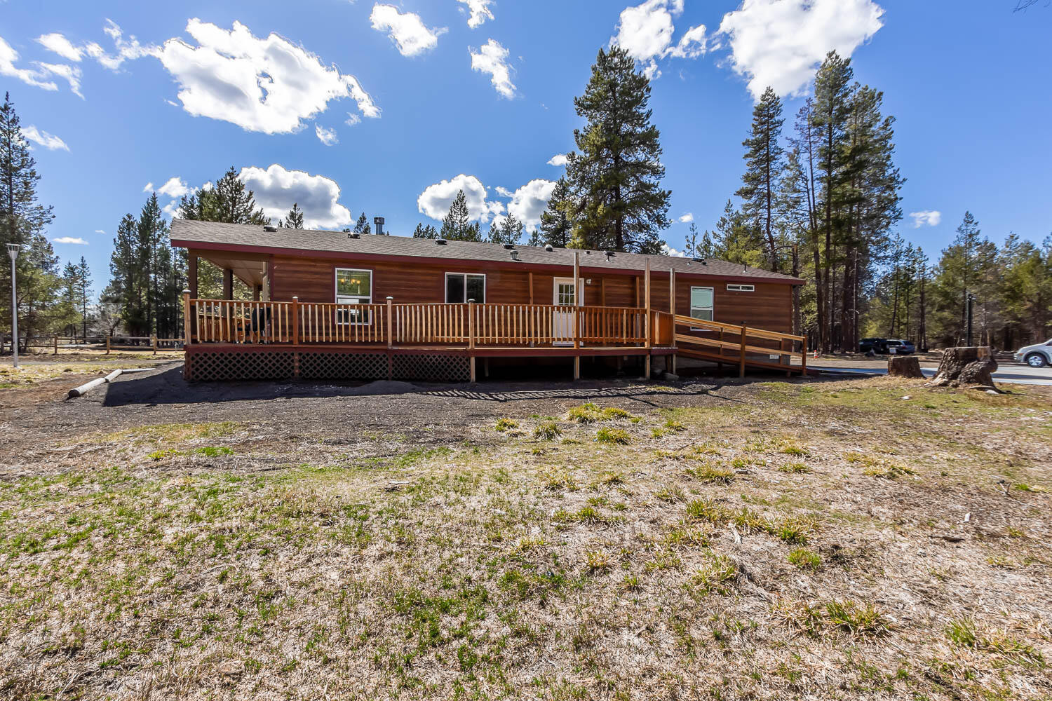 53981 Pine Grove Road La Pine, OR 97739 - Photo 22 of 41 back view of home. Features a covered deck front and back with wheelchair accessible ramp.