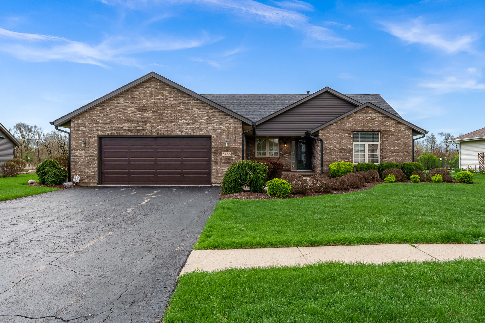 6465 Corina's Curve Rockford, IL 61103 - Photo 1 of 48 a front view of a house with a garden