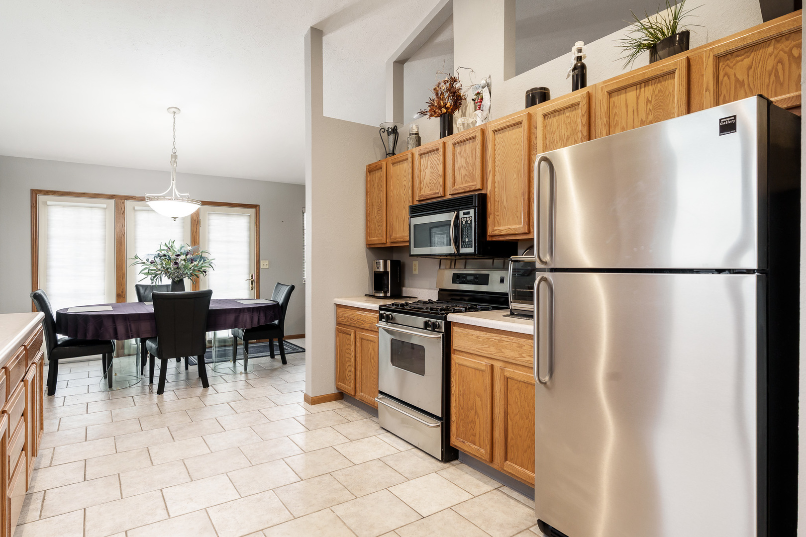 6465 Corina's Curve Rockford, IL 61103 - Photo 18 of 48 a kitchen with stainless steel appliances granite countertop a refrigerator a stove a dining table and chairs