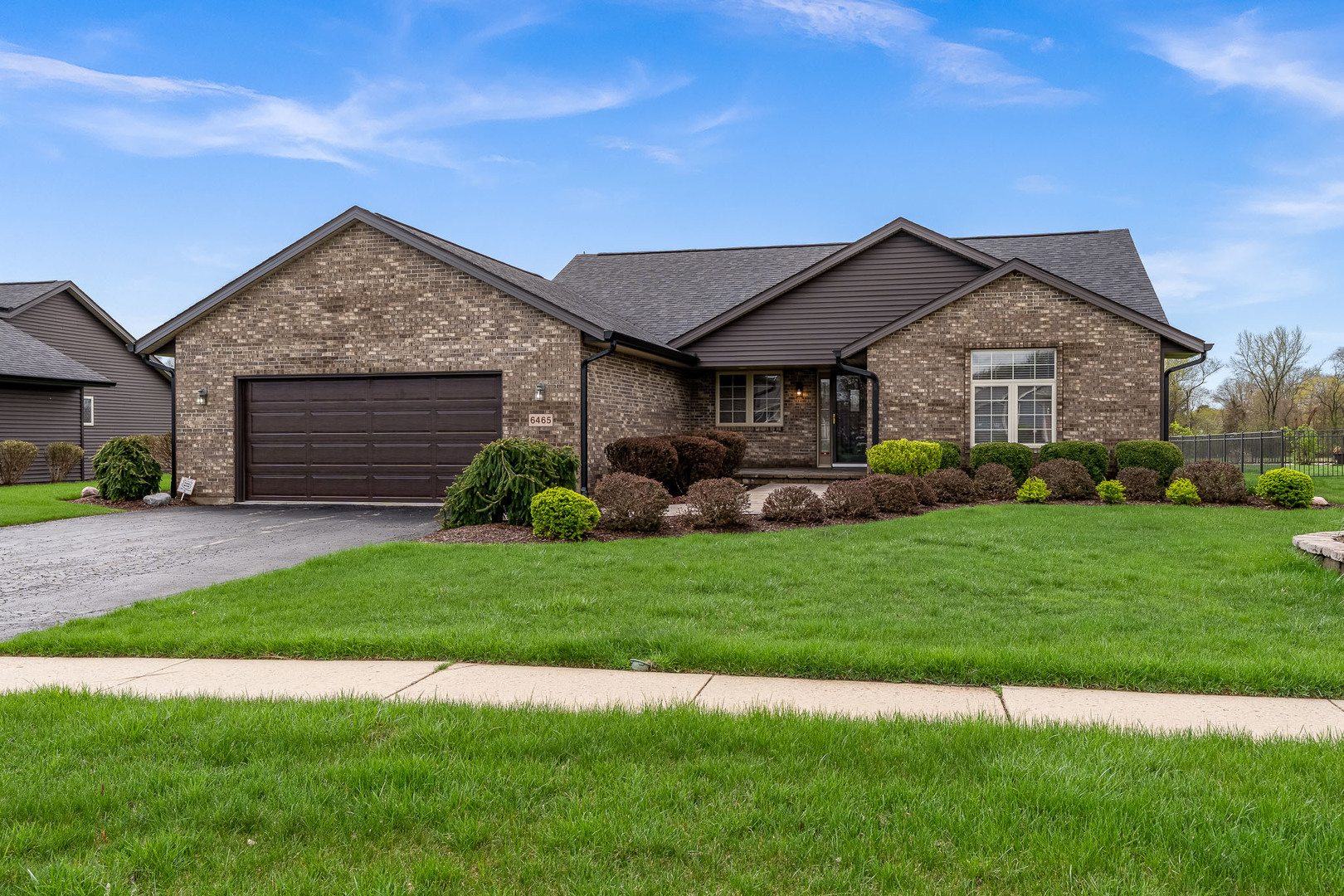 6465 Corina's Curve Rockford, IL 61103 - Photo 2 of 48 a front view of a house with a garden and plants