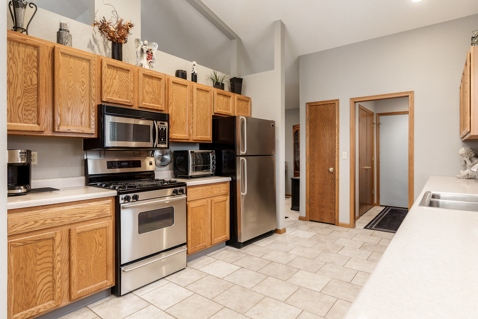 6465 Corina's Curve Rockford, IL 61103 - Photo 21 of 48 a kitchen with stainless steel appliances granite countertop a stove a refrigerator and a microwave