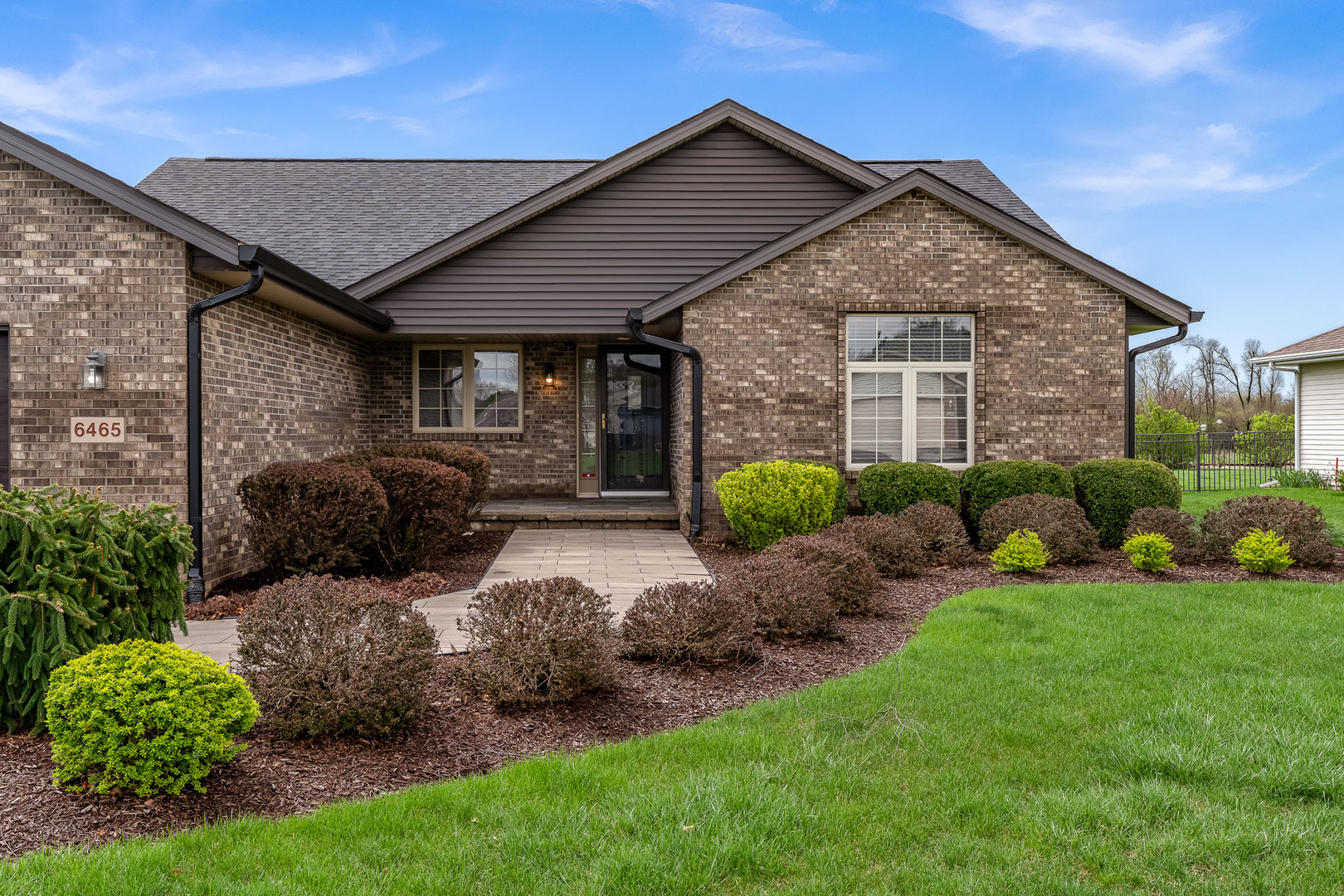 6465 Corina's Curve Rockford, IL 61103 - Photo 3 of 48 a front view of a house with a garden
