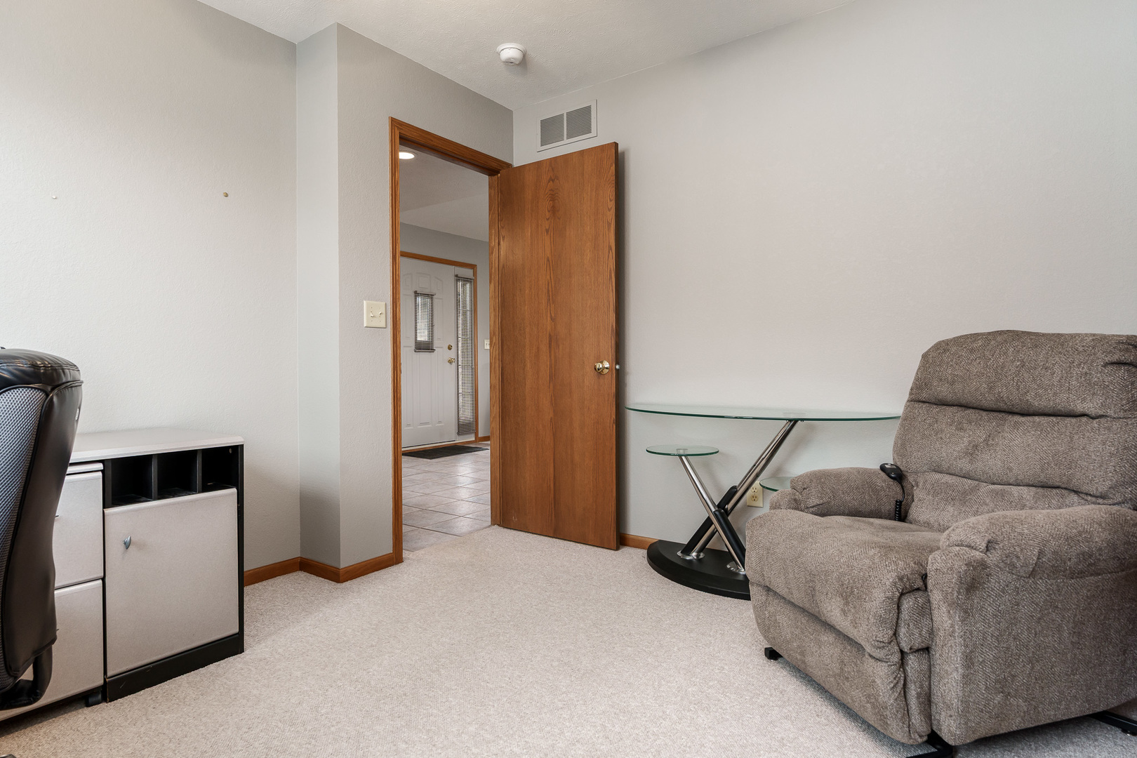 6465 Corina's Curve Rockford, IL 61103 - Photo 35 of 48 a living room with a couch and a dresser next to a window