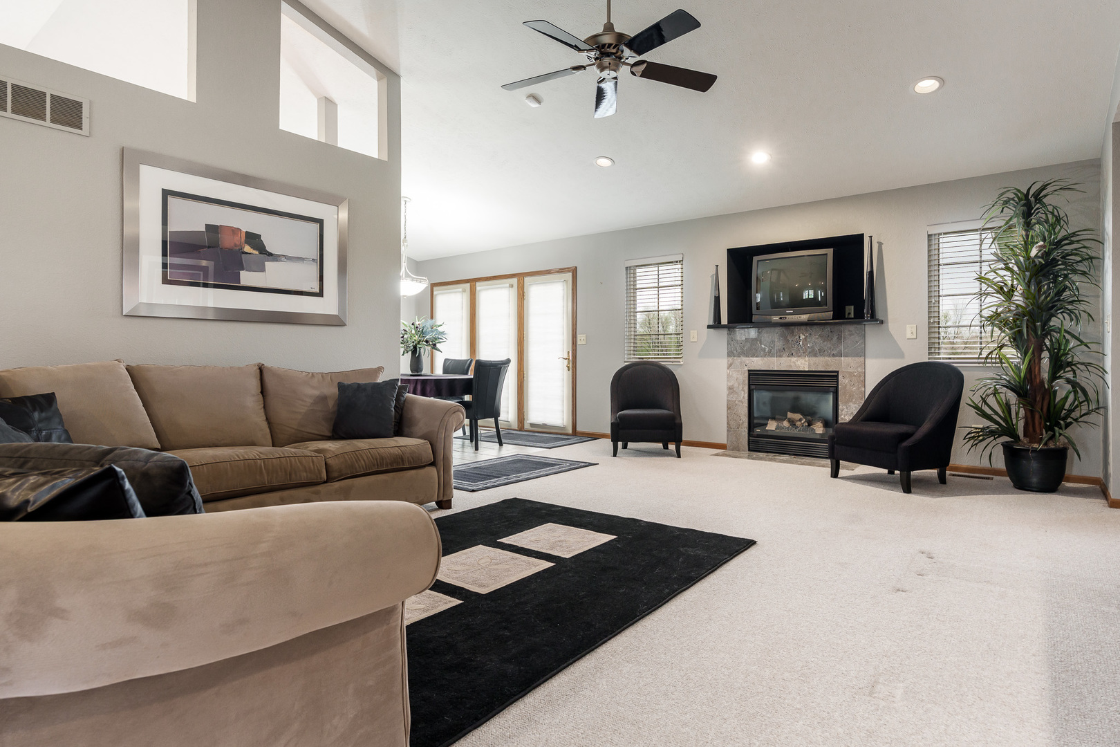 6465 Corina's Curve Rockford, IL 61103 - Photo 9 of 48 a living room with furniture a fireplace a flat screen tv and potted plant