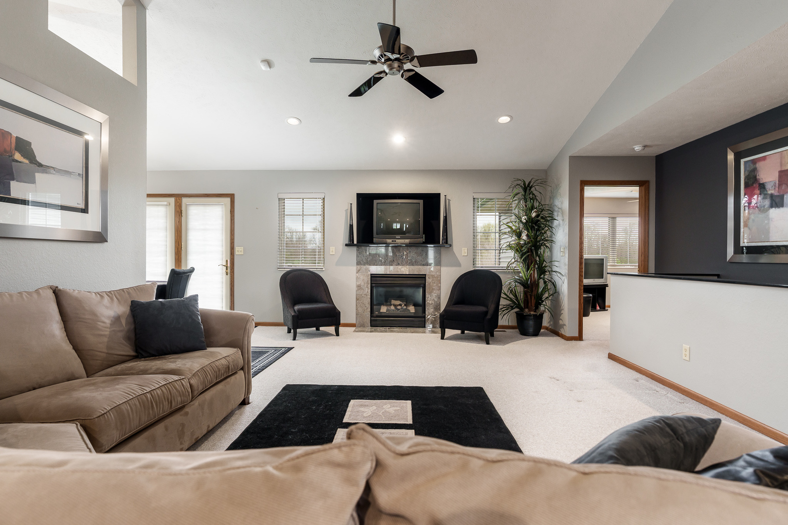 6465 Corina's Curve Rockford, IL 61103 - Photo 10 of 48 a living room with couches a fireplace and a flat screen tv