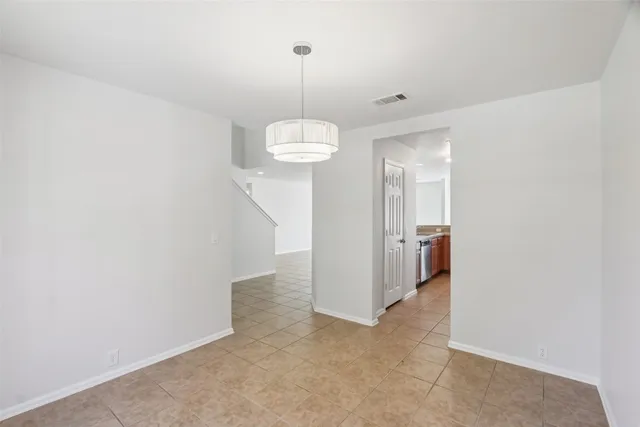 a view of a hallway with a chandelier