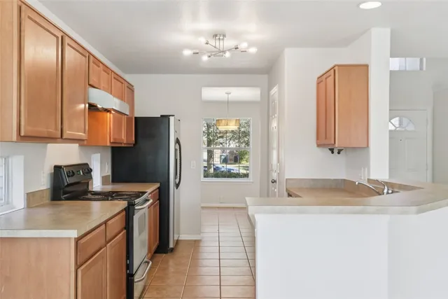 a kitchen with a sink cabinets and refrigerator
