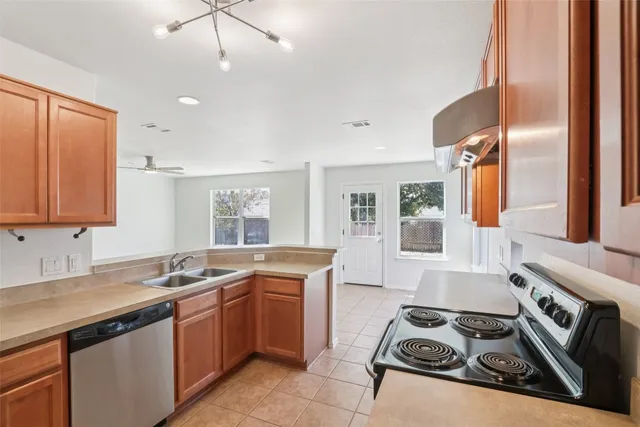 a kitchen that has a sink and a stove