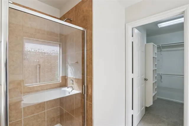 a bathroom with a glass shower door