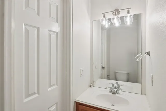 a bathroom with a sink vanity and a mirror