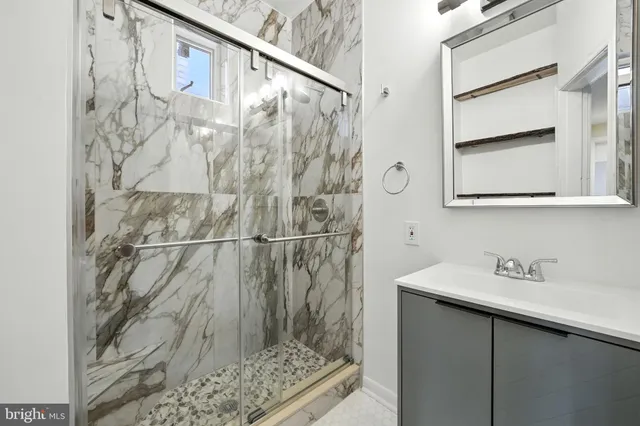 a bathroom with a shower and a sink