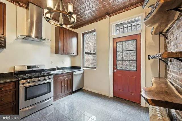 a kitchen with stainless steel appliances granite countertop a stove and a refrigerator