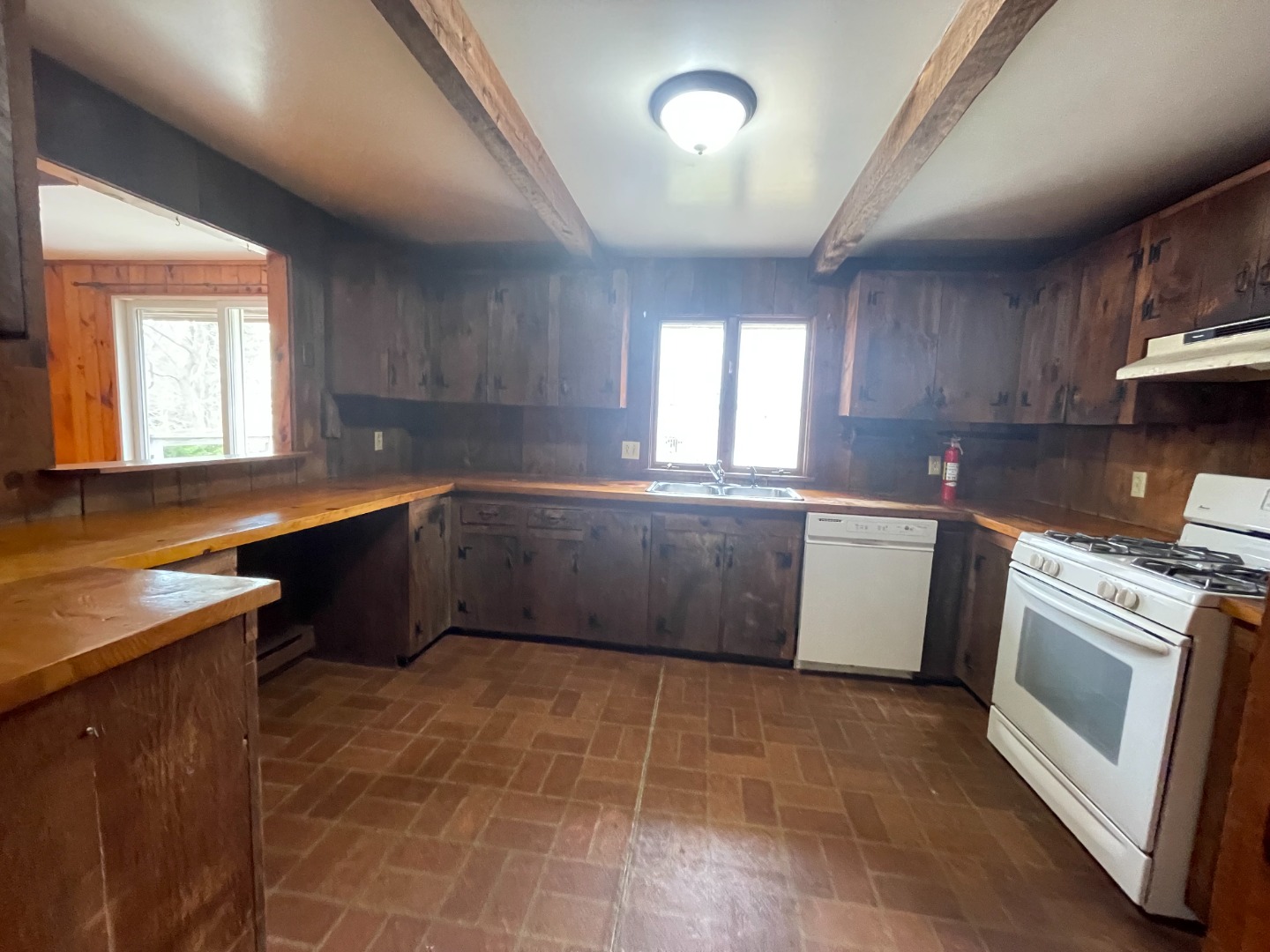 42 Marthas Road Edgartown, MA 02539 - Photo 7 of 18 a kitchen with granite countertop a sink a stove a counter space and cabinets