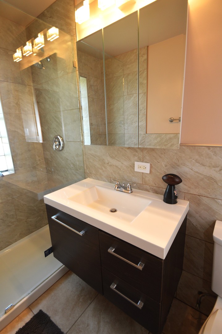 1509 Morris Avenue Berkeley, IL 60163 - Photo 16 of 28 a bathroom with a sink vanity and a mirror
