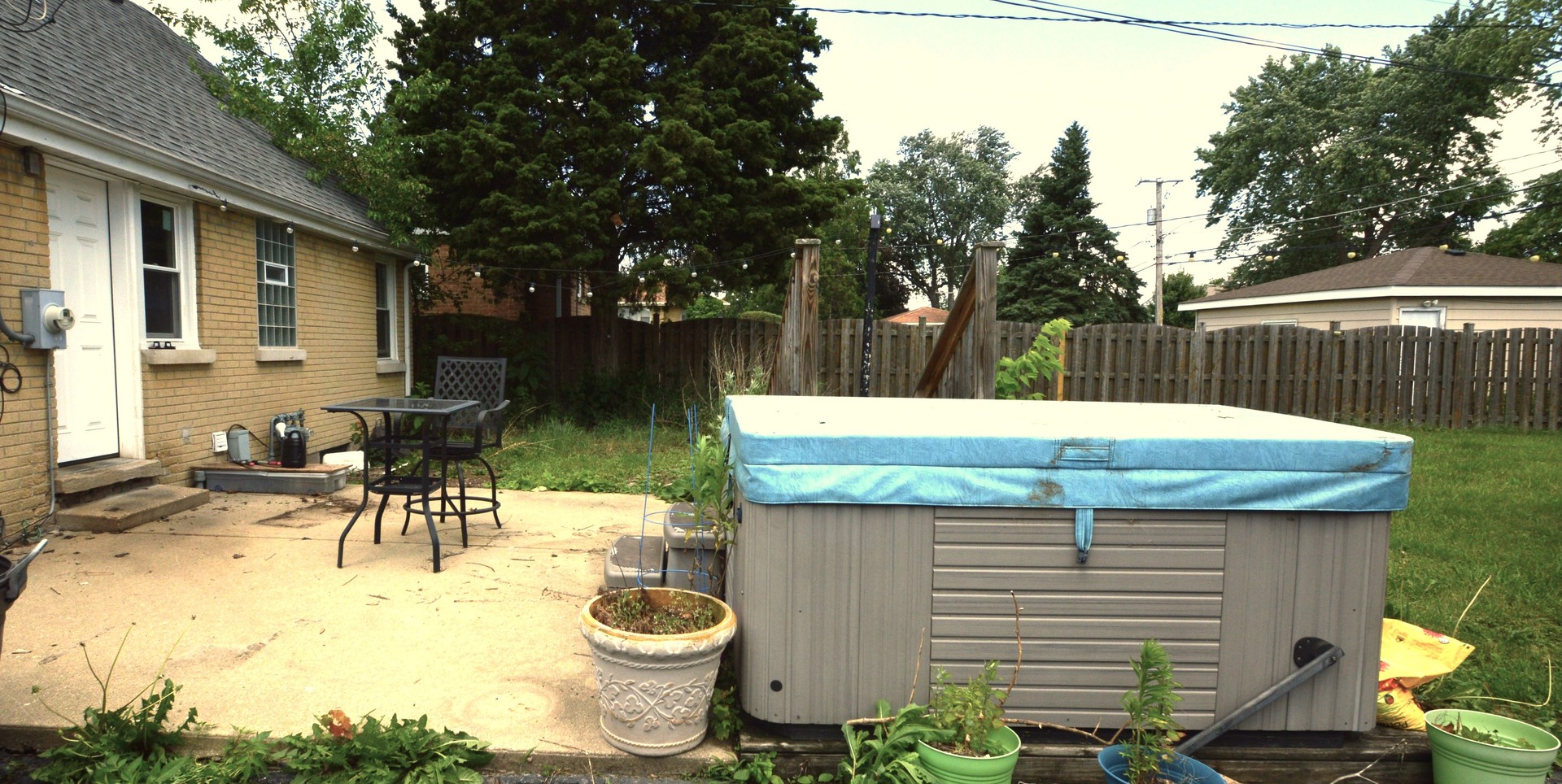 1509 Morris Avenue Berkeley, IL 60163 - Photo 27 of 28 a view of a patio with table and chairs potted plants and a palm tree