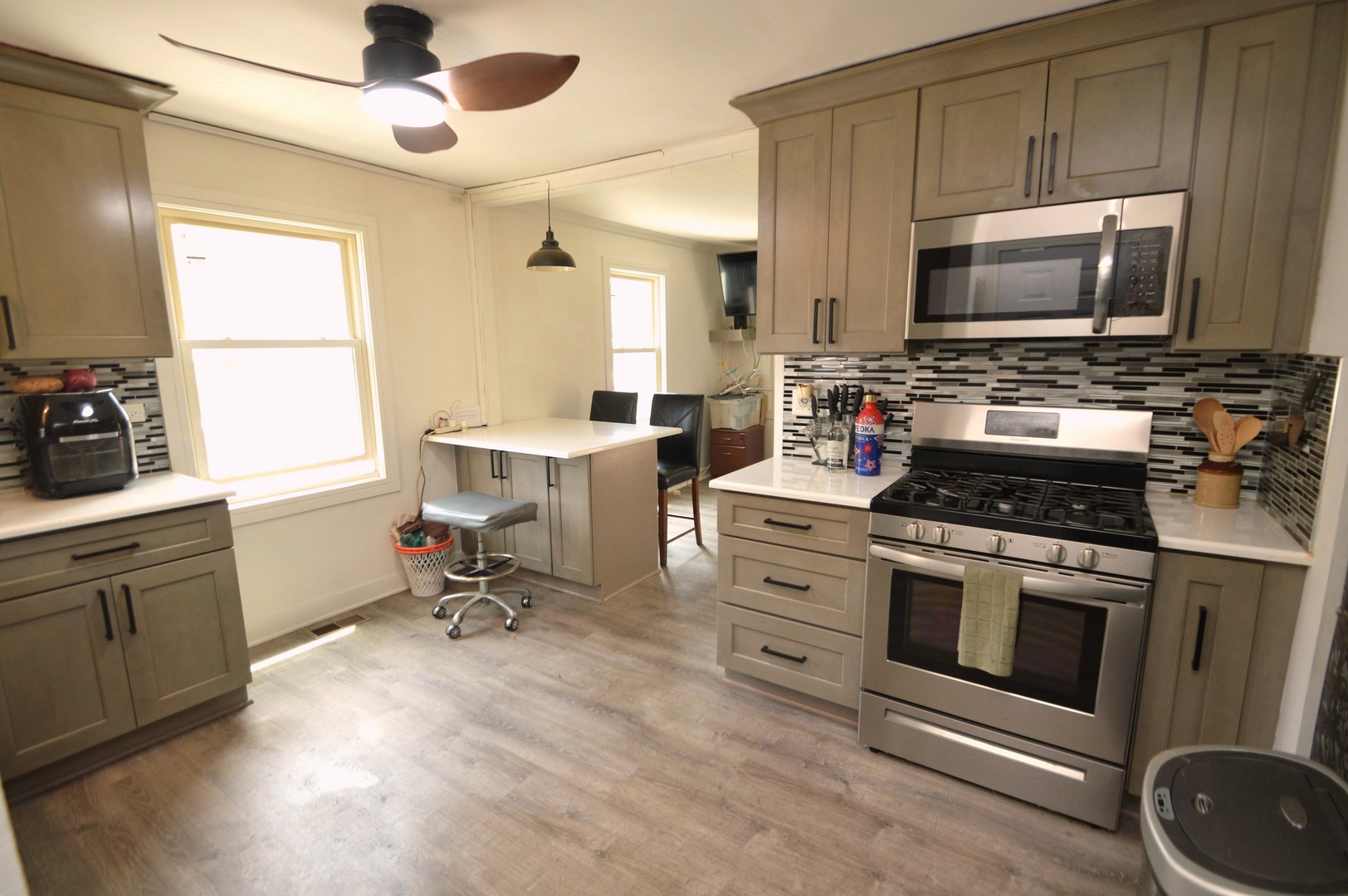 1509 Morris Avenue Berkeley, IL 60163 - Photo 9 of 28 a kitchen with a stove a sink and a microwave