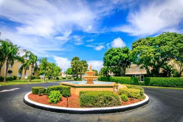 a view of a fountain in the garden of a house