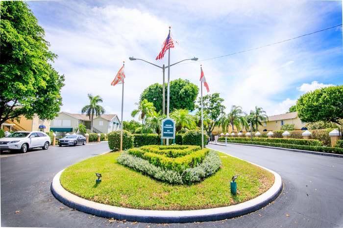 117 Waterside Drive, Unit 117 Hypoluxo, FL 33462 - Photo 18 of 19 a swimming pool with outdoor seating and yard