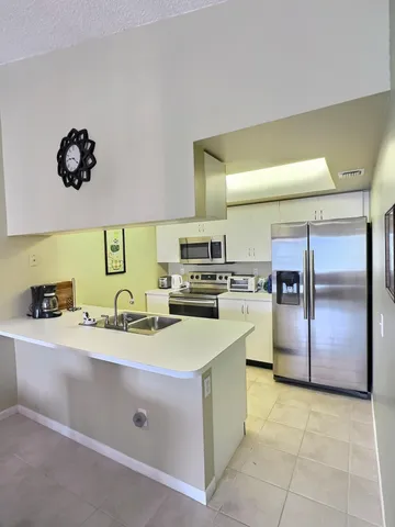 a kitchen with a sink appliances and cabinets