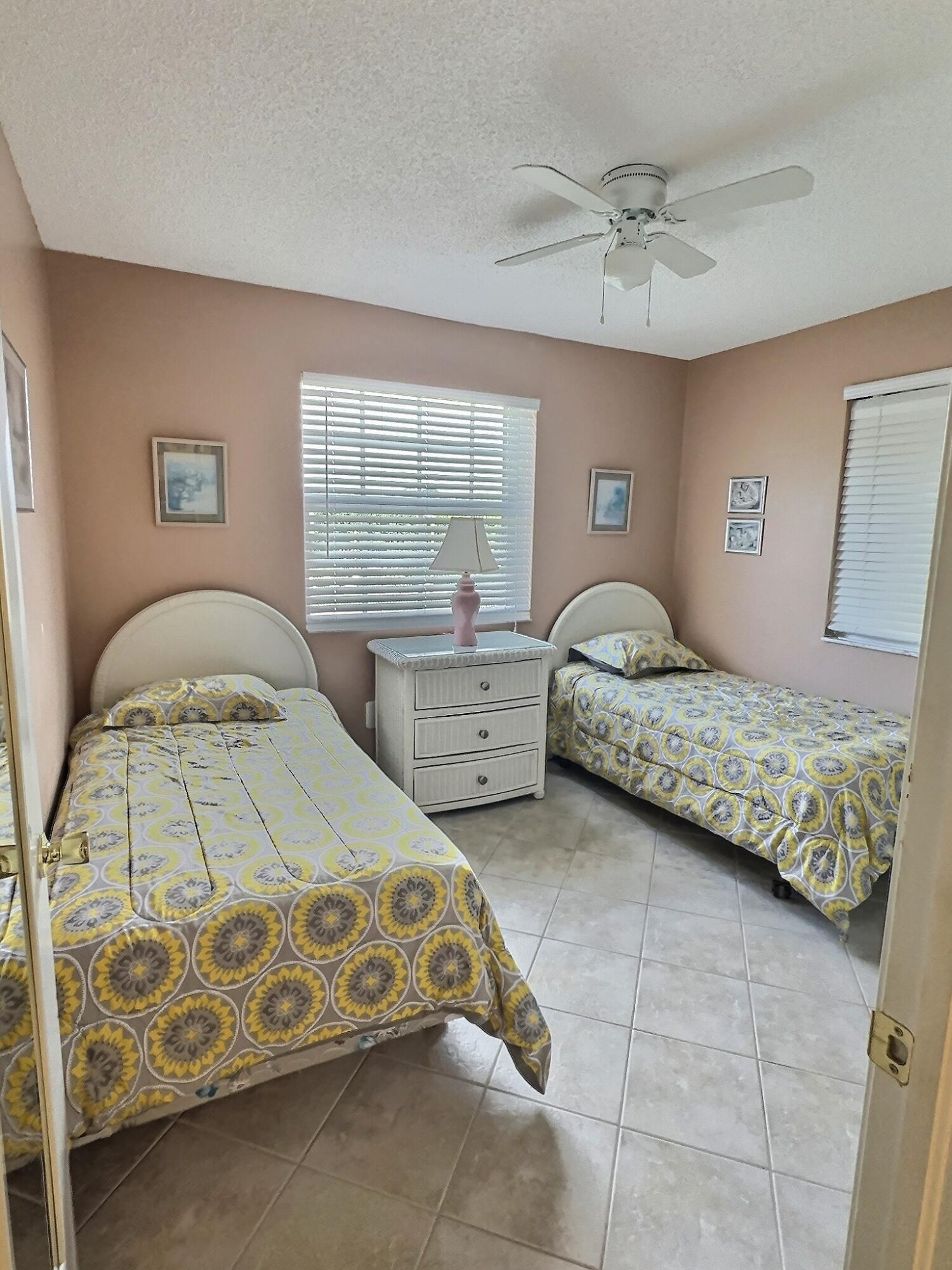 117 Waterside Drive, Unit 117 Hypoluxo, FL 33462 - Photo 10 of 19 a bedroom with a bed and window