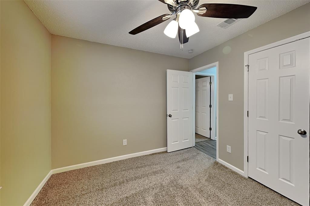 7309 Indiana Avenue Fort Worth, TX 76137 - Photo 11 of 18 Unfurnished bedroom with carpet, a ceiling fan, and a textured ceiling