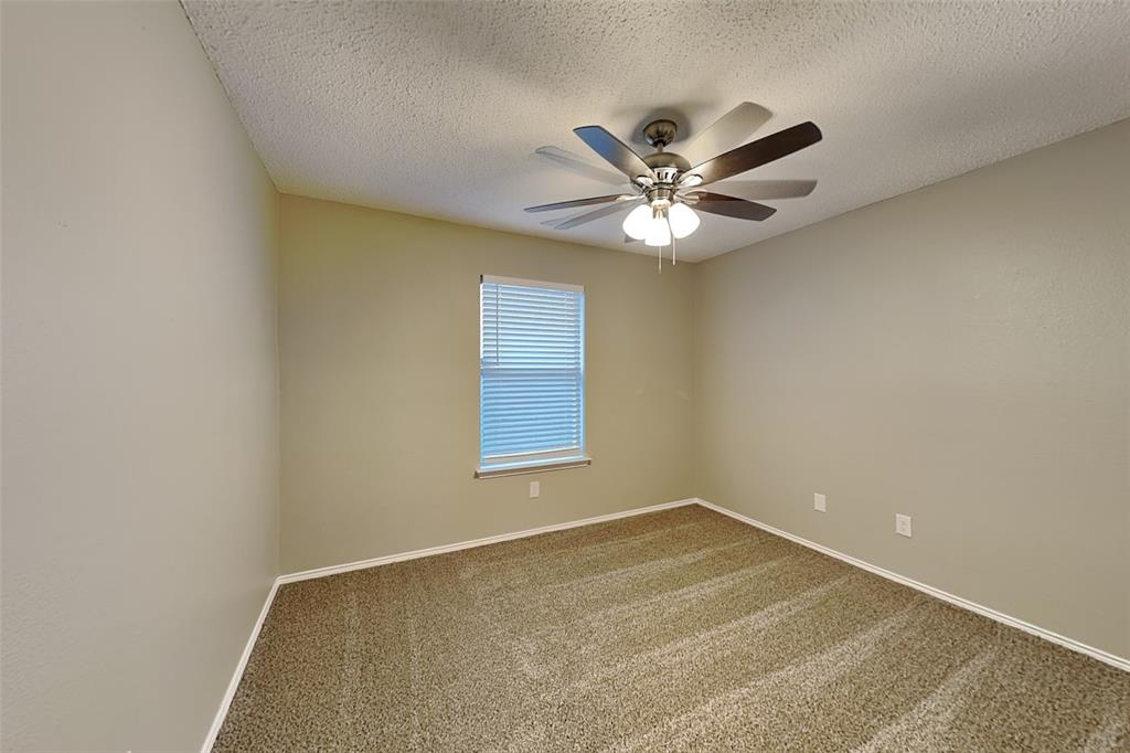 7309 Indiana Avenue Fort Worth, TX 76137 - Photo 13 of 18 Carpeted spare room featuring a textured ceiling and ceiling fan