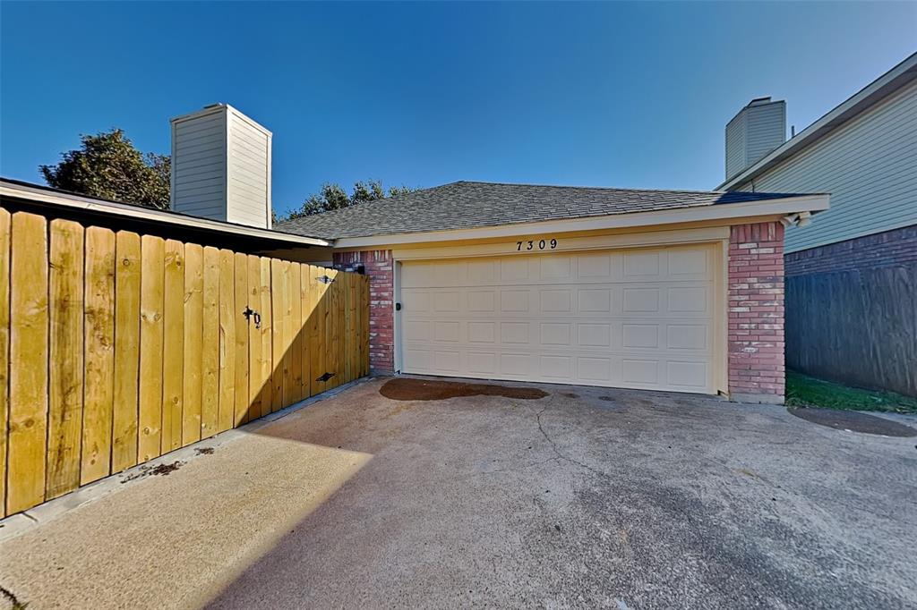 7309 Indiana Avenue Fort Worth, TX 76137 - Photo 17 of 18 Garage with asphalt driveway