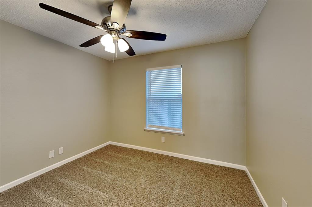7309 Indiana Avenue Fort Worth, TX 76137 - Photo 10 of 18 Carpeted spare room featuring a textured ceiling and a ceiling fan