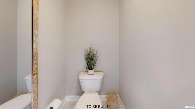 a white toilet sitting next to a shower