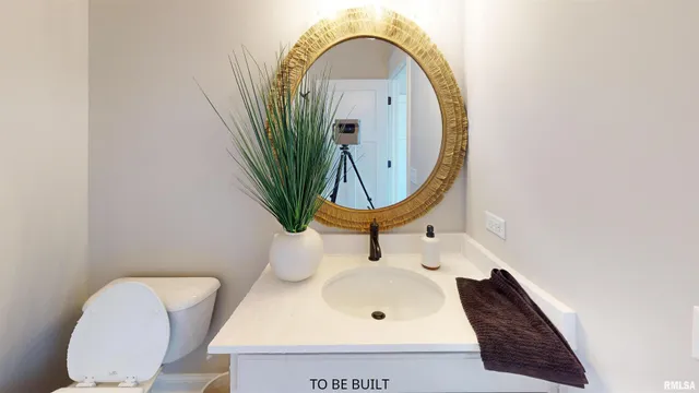 a bathroom with a toilet mirror and tub