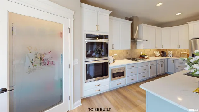 a kitchen with stainless steel appliances a refrigerator sink and cabinets