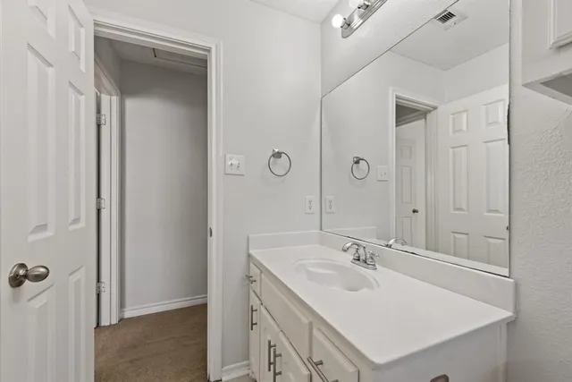 a view of backyard with wooden fence