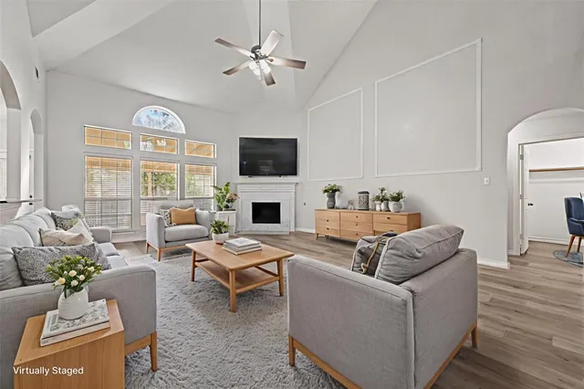 a living room with furniture a fireplace and a flat screen tv