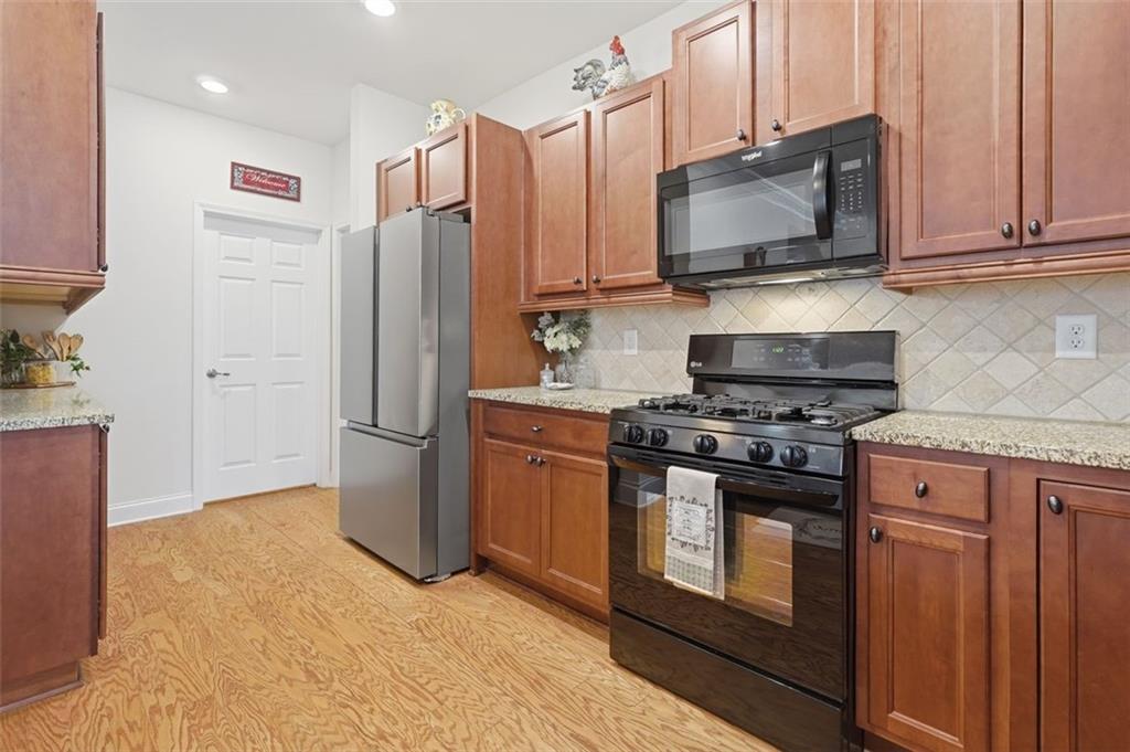 3328 Ivy Ridge Court Buford, GA 30519 - Photo 18 of 34 a kitchen with stainless steel appliances a refrigerator stove and microwave