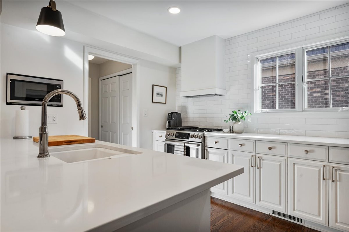 989 Ash Street Winnetka, IL 60093 - Photo 14 of 35 a kitchen with white cabinets and appliances