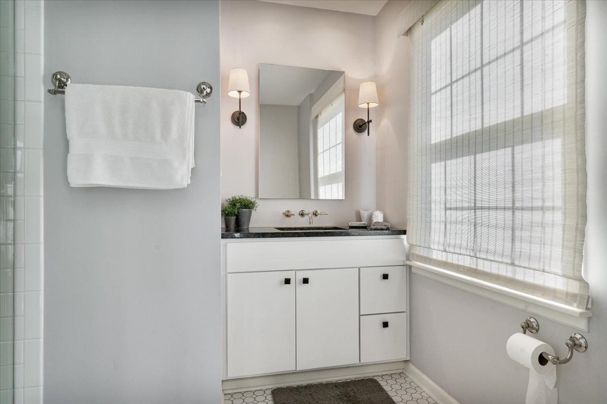 989 Ash Street Winnetka, IL 60093 - Photo 24 of 35 a bathroom with a granite countertop sink and a mirror