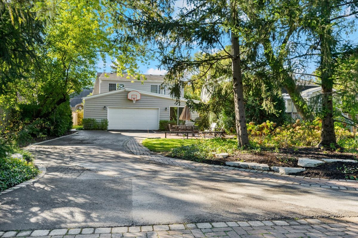 989 Ash Street Winnetka, IL 60093 - Photo 30 of 35 a front view of a house with a yard and a garage